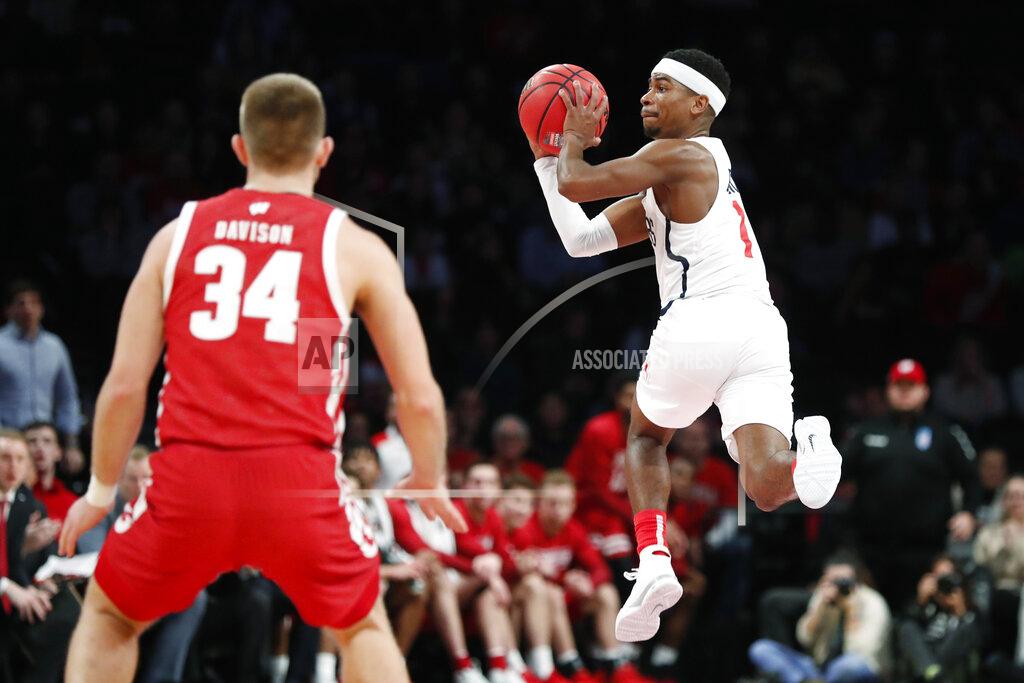 Kathy Willens Richmond guard Blake Francis (1) passes as Wisconsin guard Brad Davison (34) watches during the second half of an NCAA college basketball game in the Legends Classic, Monday, Nov. 25, 2019, in New York. Richmond defeated Wisconsin 62-52. (AP Photo/Kathy Willens)