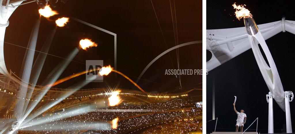 Uncredited The Olympic cauldron rises in this multiple exposure photo, left, after Nikolas Kaklamanakis, right, lit it during the Opening Ceremony of the 2004 Olympic Games in Athens, Friday, Aug. 13, 2004. The photo at left is a single frame time exposure interrupted at six intervals while the Olympic cauldron rises after being lit. (AP Photos)