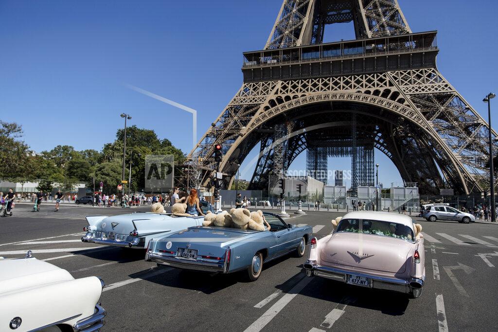 Lewis Joly Teddy bears, set up by Philippe Labourel, who wants to be named 'Le papa des nounours' (Teddy Bears father) are pictured inside American vintage cars driving through Paris, Sunday, June, 13, 2021. The event took place in a show of support for the tourism industry which was hit by the COVID-19 pandemic. (AP Photo/Lewis Joly)