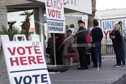 FILE - In this Feb. 15, 2020, file photo, people wait in line at an early voting location at the culinary workers union hall in Las Vegas. A businessman is facing criminal charges of voting twice in the November 2020 election, including voting with his dead wife's ballot. Nevada state Attorney General Aaron Ford announced Thursday, Oct. 21, 2021, that Donald "Kirk" Hartle faces felony charges that could get him up to eight years in prison (AP Photo/John Locher, File)