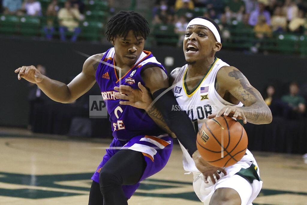 Rod Aydelotte Baylor guard James Akinjo, right, is fouled by Northwestern State guard Brian White during the first half of an NCAA college basketball game Tuesday, Dec. 28, 2021, in Waco, Texas. (AP Photo/Rod Aydelotte)
