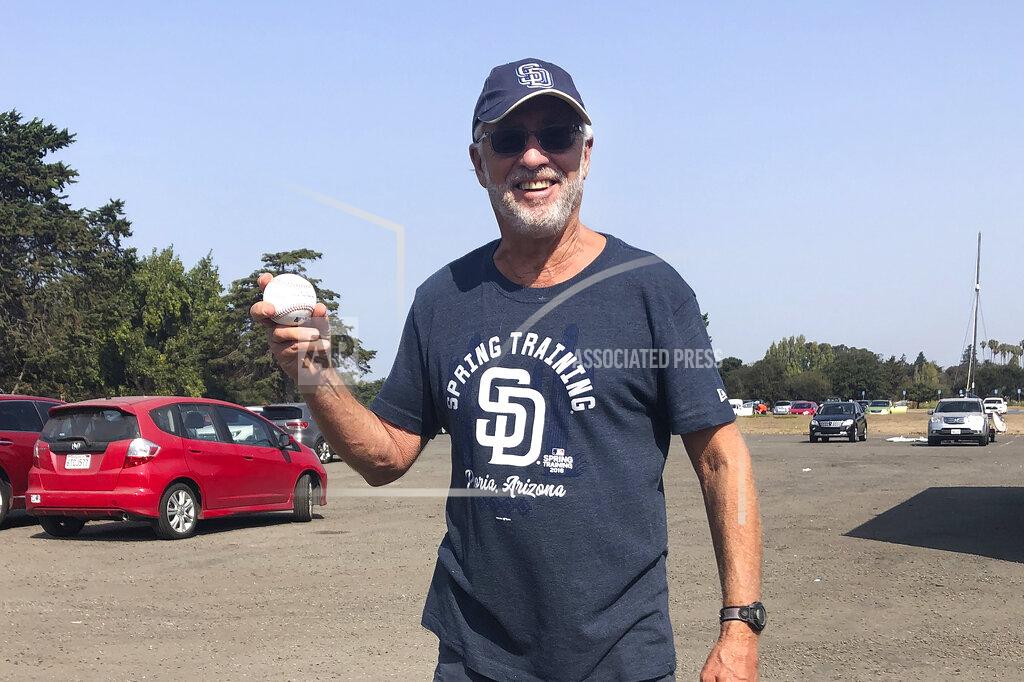 Janie Mccauley San Diego Padres fan Bob Gans, of La Jolla, Calif., holds his foul ball surprise at Washington Park, Sunday, Sept. 20, 2020, in Alameda, Calif. (AP Photo/Janie McCauley)