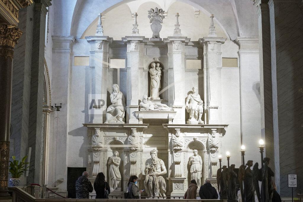 Andrew Medichini Visitors admire the tomb of Pope Julius II, with the central marble statue of Mosè, made by Italian sculptor Michelangelo Buonarroti between 1505 and 1545, inside the San Pietro in Vincoli church, in Rome, Friday, Dec. 11, 2020. Like elsewhere in Europe, museums and art galleries in Italy were closed this fall to contain the spread of COVID-19, meaning art lovers must rely on virtual tours to catch a glimpse of the treasures held by famous institutions such as the Uffizi in Florence and the Vatican Museums in Rome. However, some exquisite gems of Italy's cultural heritage remain on display in real life inside the country's churches, some of which have collections of renaissance art and iconography that would be the envy of any museum. (AP Photo/Andrew Medichini)