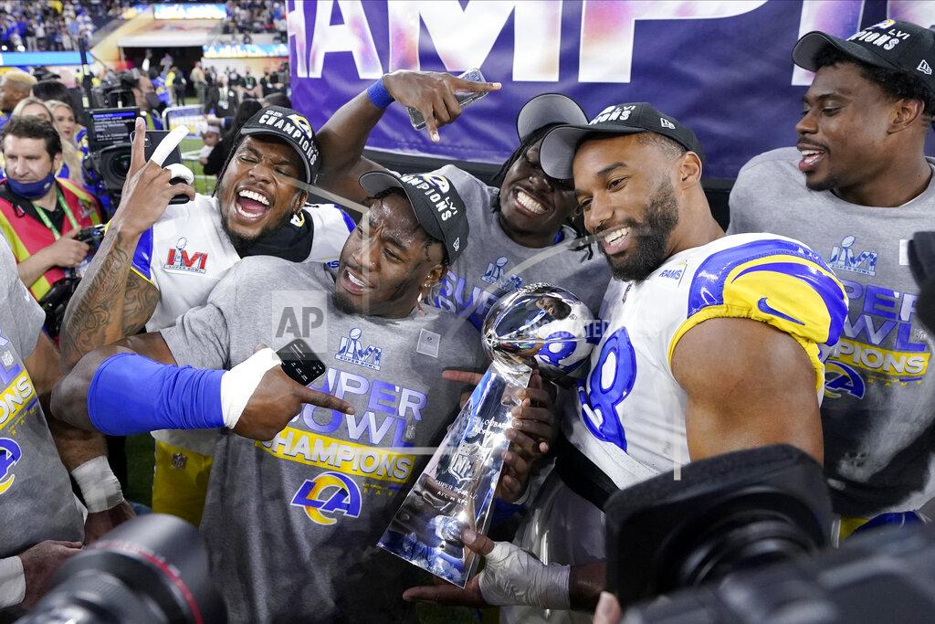 Mark J. Terrill FILE - Los Angeles Rams players celebrate with the Lombardi Trophy after defeating the Cincinnati Bengals in the NFL Super Bowl 56 football game Sunday, Feb. 13, 2022, in Inglewood, Calif. The defending Super Bowl champion Los Angeles Rams host the Buffalo Bills in a battle of teams expected to challenge for the Lombardi Trophy to open the NFL season on Thursday night. (AP Photo/Mark J. Terrill, File