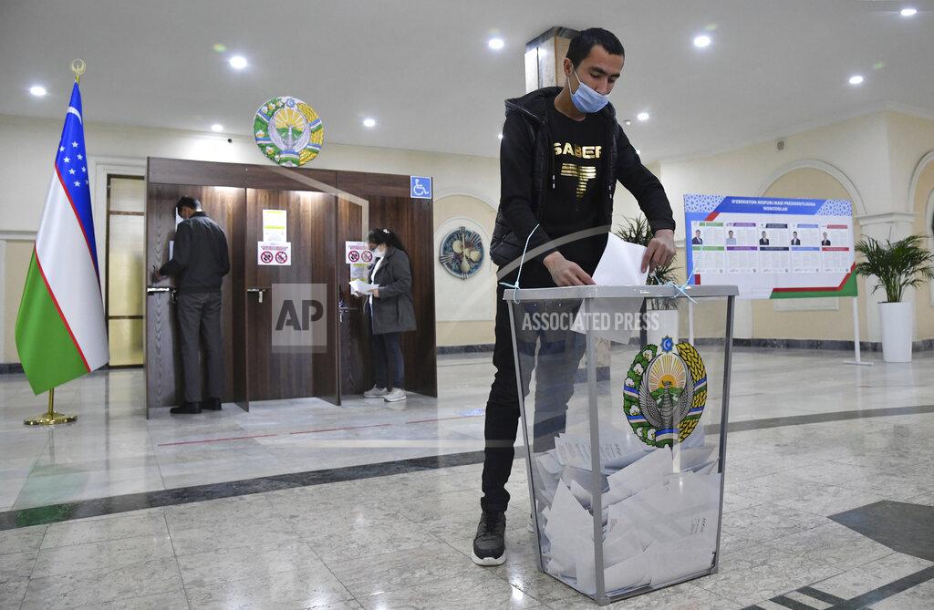 Uncredited A man casts his ballot at a polling station during the presidential election in Tashkent, Uzbekistan, Sunday, Oct. 24, 2021. Uzbeks voted Sunday in a presidential election that the incumbent is expected to win in a landslide against weak competition. Although Shavkat Mirziyoyev has relaxed many of the policies of his dictatorial predecessor, he has made little effort at political reform. He took office in 2016 upon the death of Islam Karimov and faces four relatively low-visibility candidates who did not even show up for televised debates. (AP Photo)
