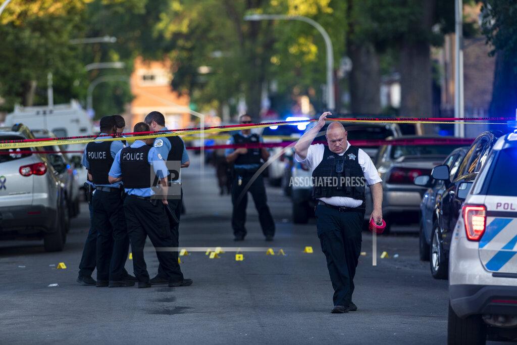 Tyler Lariviere Chicago police officers investigate the scene of a deadly shooting in Chicago on Sunday, July 5, 2020, where a 7-year-old girl and a man were fatally shot during a Fourth of July party Saturday. At least a dozen people were killed in Chicago over the Fourth of July weekend, police said. Scores of people were shot and wounded. (Tyler LaRiviere/Chicago Sun-Times via AP)