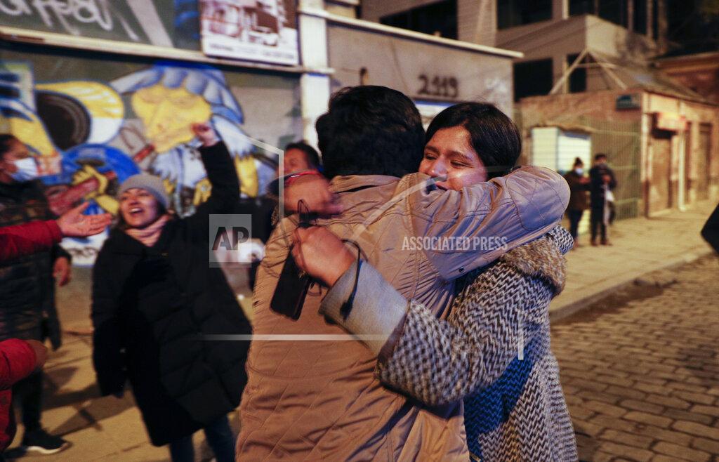 Juan Karita Supporters of Luis Arce, presidential candidate for the Movement Towards Socialism (MAS) party, embrace each other as they claimed victory after general elections in La Paz, Bolivia, Monday, Oct. 19, 2020. (AP Photo/Juan Karita)
