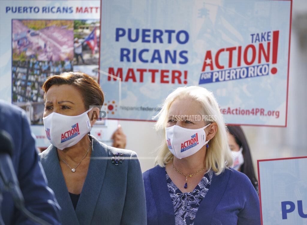 J. Scott Applewhite Rep. Nydia Velazquez, D-N.Y., left, and Sen. Kirsten Gillibrand, D-N.Y., join advocates for Puerto Rico which Senate Majority Leader Chuck Schumer, D-N.Y., joins advocates for Puerto Rico, which still suffers from the effects of Hurricane Maria in 2017, at the Capitol in Washington, Monday, Sept. 20, 2021. (AP Photo/J. Scott Applewhite)