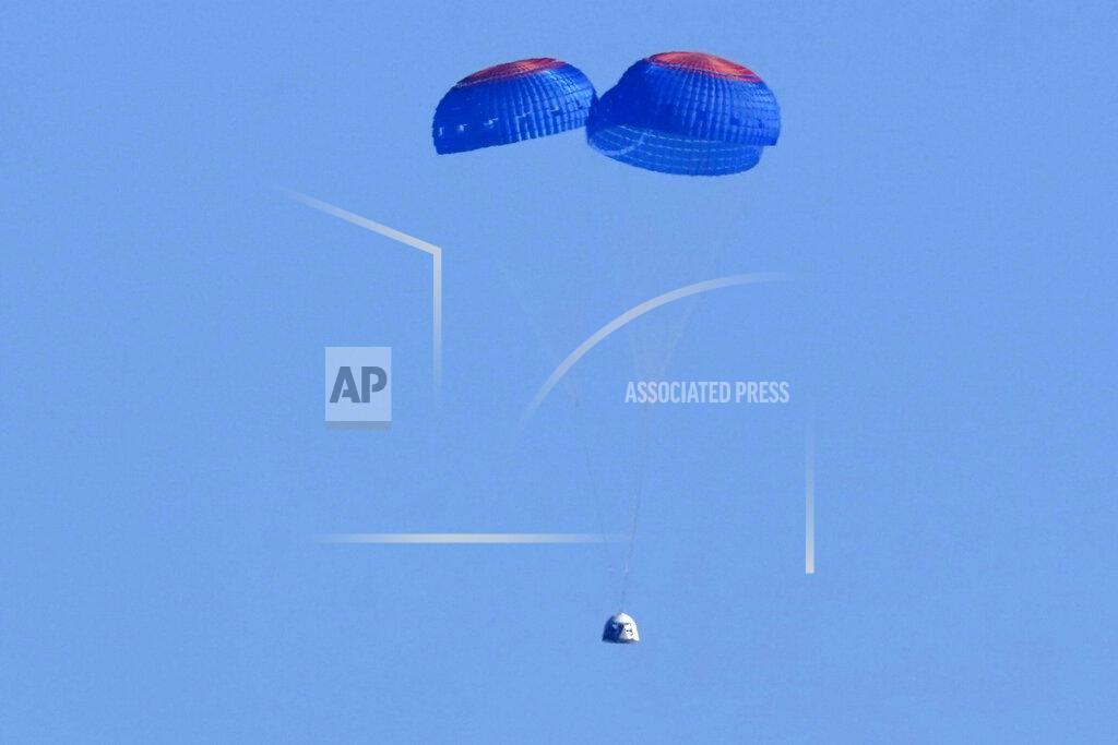 Lm Otero Parachutes slow the descent of the Blue Origin capsule with passengers William Shatner, Chris Boshuizen, Audrey Powers and Glen de Vries near the company's spaceport near Van Horn, Texas, Wednesday, Oct. 13, 2021. (AP Photo/LM Otero)