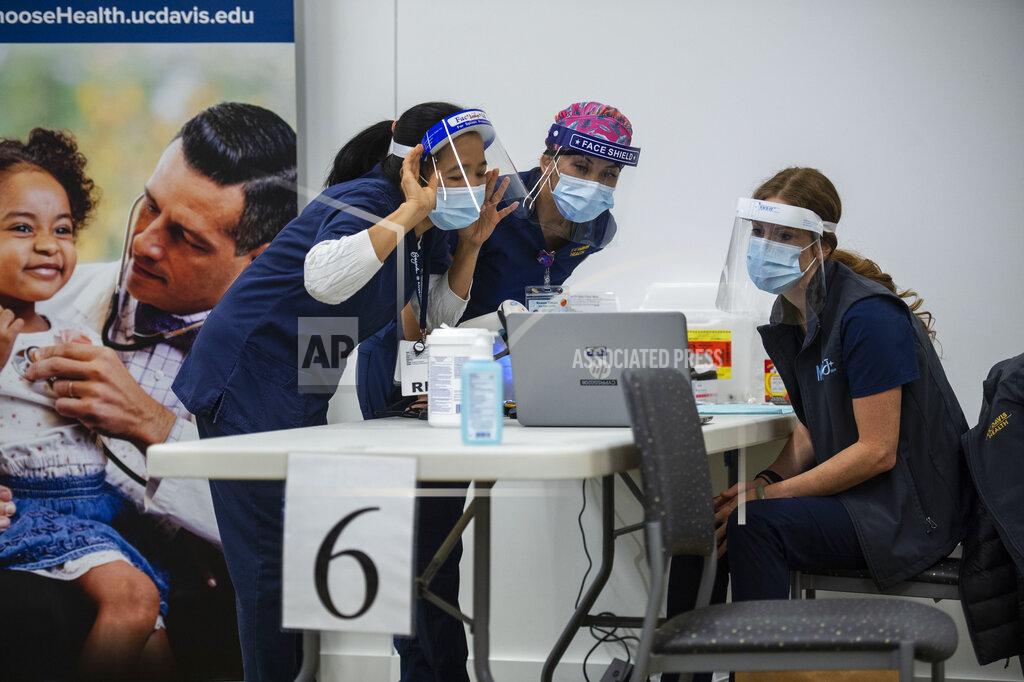 Hector Amezcua UC Davis Medical Center nurses, from left, Analyn Corpuz, Raenne Takara and Heather Donaldson review the process of inoculating with the Pfizer-BioNTech COVID-19 vaccine, Tuesday, Dec. 15, 2020 in Sacramento, Calif. (AP Photo/Hector Amezcua, Pool)