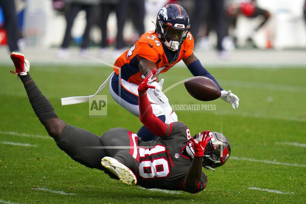 Jack Dempsey Tampa Bay Buccaneers wide receiver Tyler Johnson, below, can't make the catch as Denver Broncos defensive back Essang Bassey defends during the second half of an NFL football game Sunday, Sept. 27, 2020, in Denver. (AP Photo/Jack Dempsey)