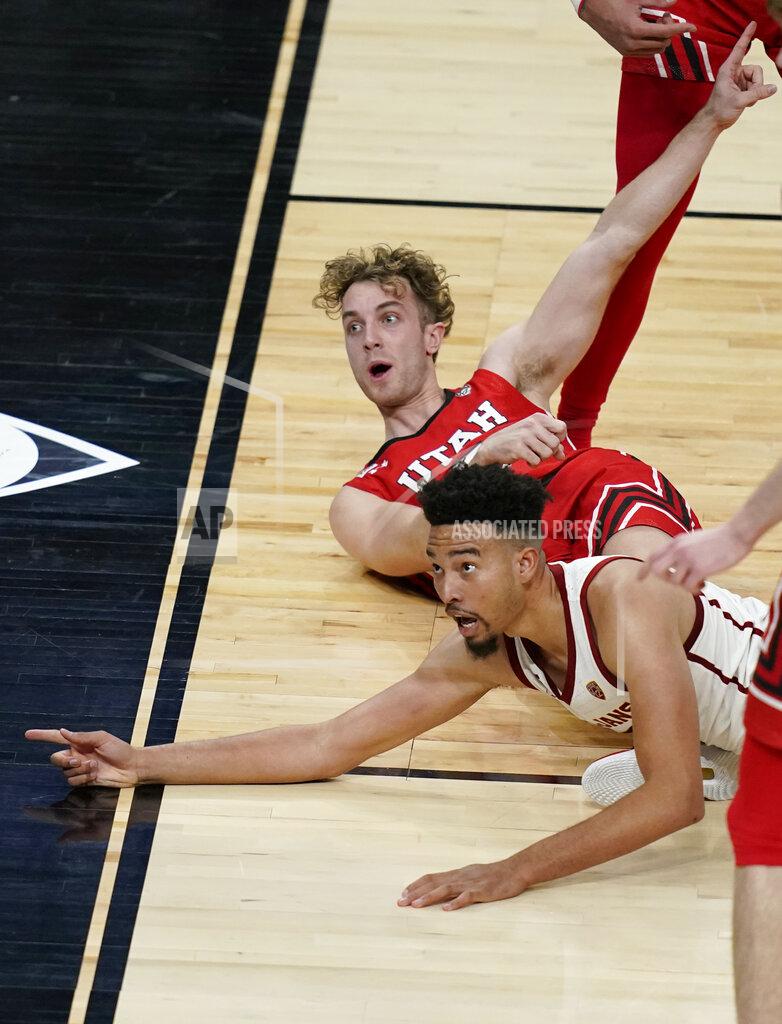 John Locher Southern California's Isaiah Mobley, bottom, and Utah's Jaxon Brenchley (5) react after a play during the second overtime of an NCAA college basketball game in the quarterfinal round of the Pac-12 men's tournament Thursday, March 11, 2021, in Las Vegas. (AP Photo/John Locher)