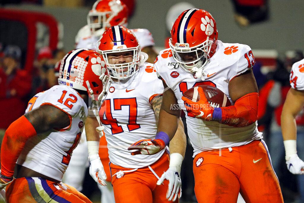 Karl B Deblaker Clemson's Tyler Davis (13) celebrates a fumble recovery with teammates James Skalski (47) and K'Von Wallace (12) during the first half of an NCAA college football game against North Carolina State in Raleigh, N.C., Saturday, Nov. 9, 2019. (AP Photo/Karl B DeBlaker)