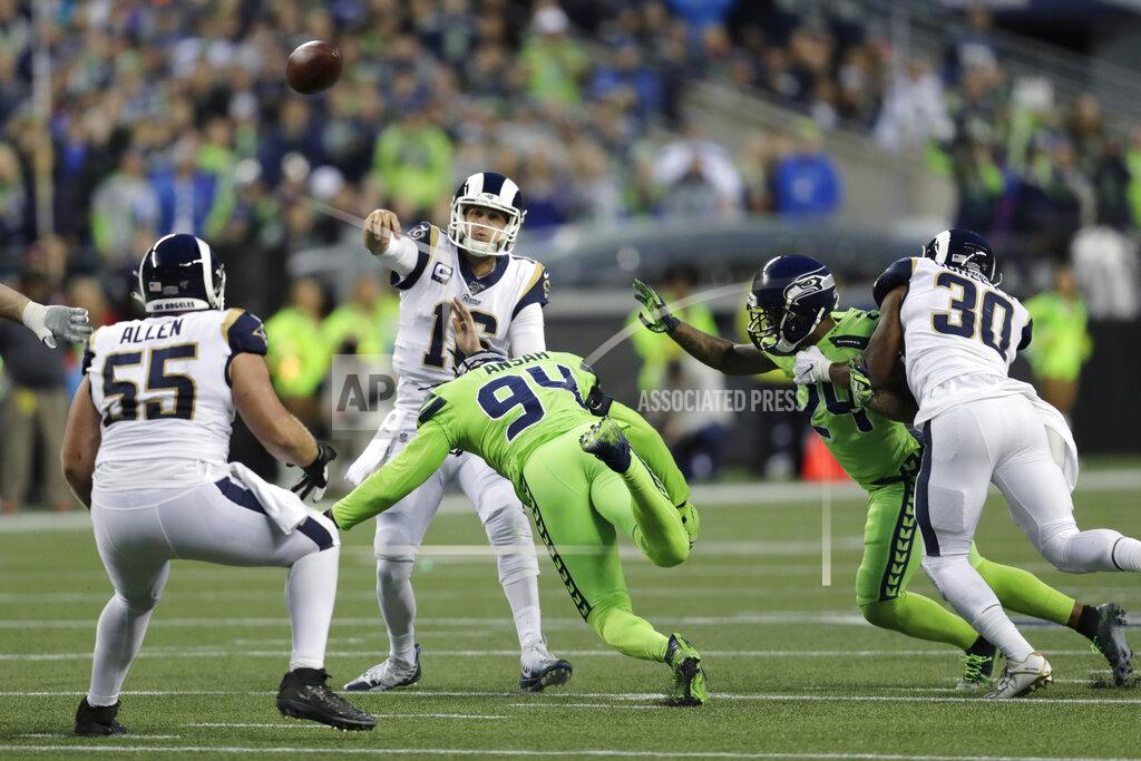 Stephen Brashear Los Angeles Rams quarterback Jared Goff, center, passes under pressure from Seattle Seahawks defensive end Ziggy Ansah (94) during the first half of an NFL football game Thursday, Oct. 3, 2019, in Seattle. (AP Photo/Stephen Brashear)