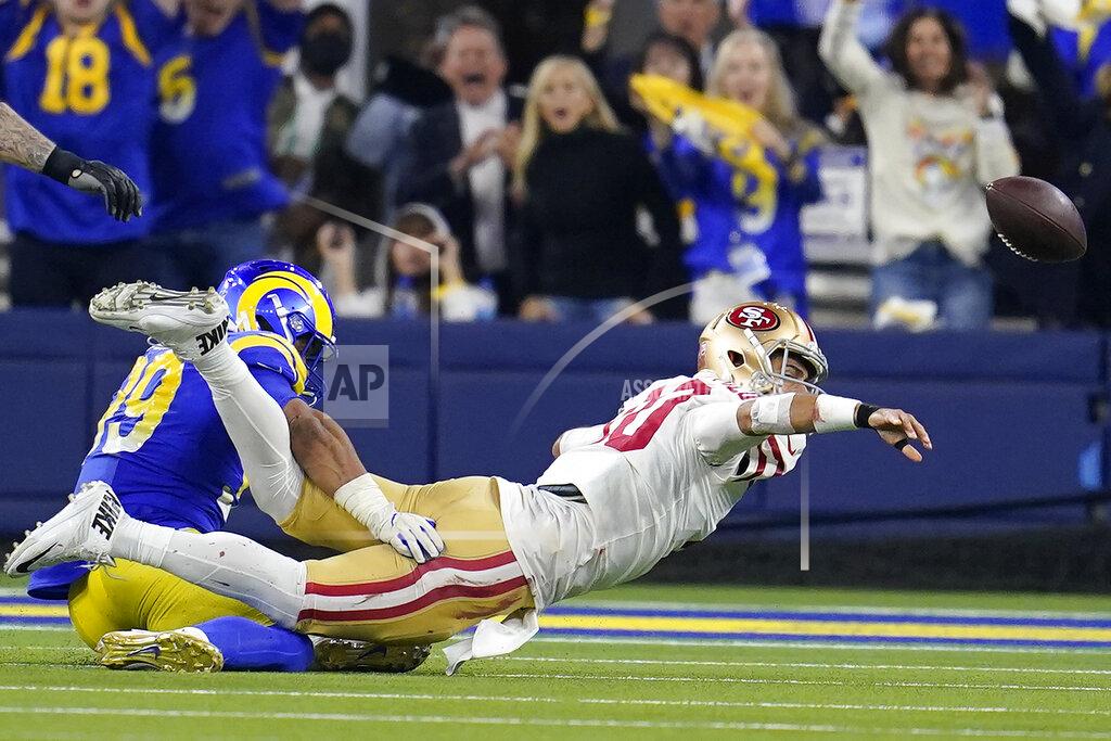 Marcio Jose Sanchez San Francisco 49ers quarterback Jimmy Garoppolo, right, throws an interception against the Los Angeles Rams during the second half of the NFC Championship NFL football game Sunday, Jan. 30, 2022, in Inglewood, Calif. (AP Photo/Marcio Jose Sanchez)