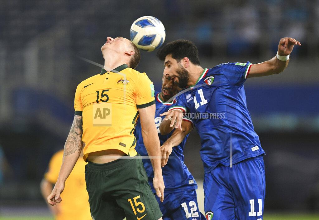 Jaber Abdulkhaleg Australia's Mitchell Duke, left, jumps for the ball with Kuwait's Fahed Alansari, right, during the World Cup 2022 Group B qualifying soccer match between Kuwait and Australia in Kuwait City, Kuwait, Thursday, June 3, 2021. (AP Photo/Jaber Abdulkhaleg)