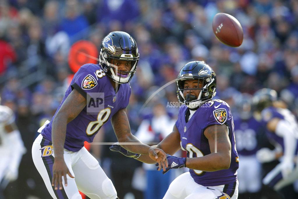 Carolyn Kaster Baltimore Ravens quarterback Lamar Jackson, left, and running back Kenneth Dixon chase after a loose ball in the first half of an NFL wild card playoff football game against the Los Angeles Chargers, Sunday, Jan. 6, 2019, in Baltimore. (AP Photo/Carolyn Kaster)