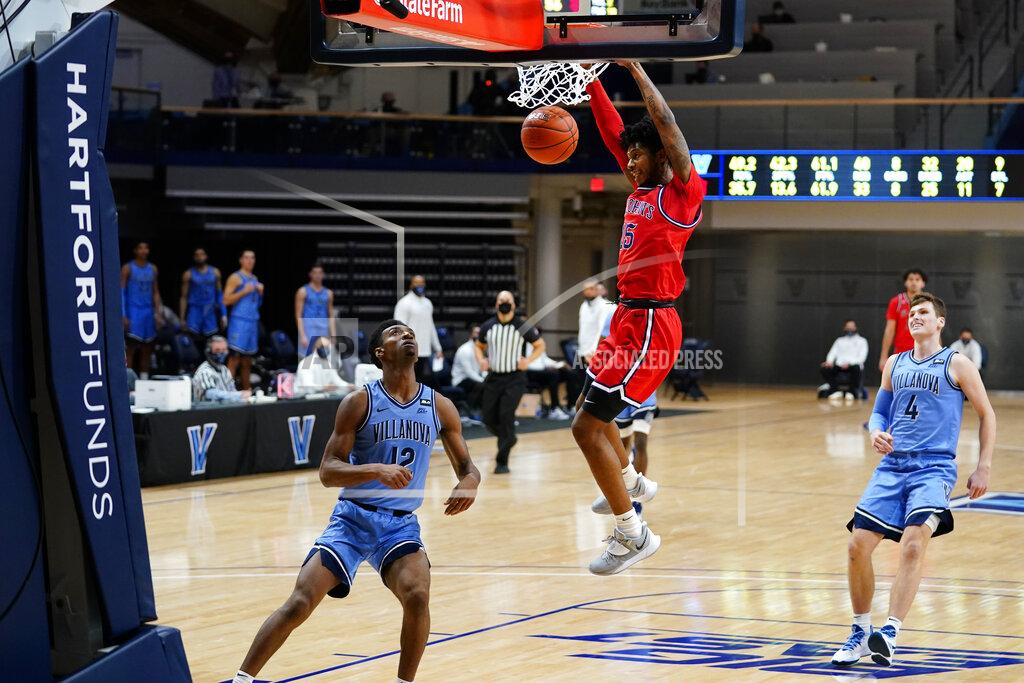 Matt Slocum St. John's Vince Cole (15) dunks past Villanova's Trey Patterson (12) during the second half of an NCAA college basketball game, Tuesday, Feb. 23, 2021, in Villanova, Pa. (AP Photo/Matt Slocum)