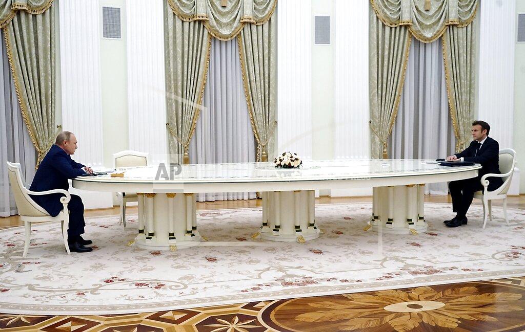 Uncredited FILE - Russian President Vladimir Putin, left, listens to French President Emmanuel Macron during their meeting in the Kremlin in Moscow, Russia, Feb. 7, 2022. In the rare public recording of a discussion between two world leaders, Macron tries to convince the Russian president to "calm things down" in the region. But all his suggestions reach a dead end on Putin's side. (Sputnik, Kremlin Pool Photo via AP, File)