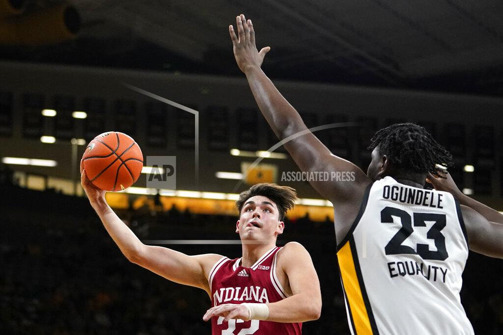 Charlie Neibergall Indiana guard Trey Galloway (32) drives to the basket past Iowa forward Josh Ogundele (23) during the first half of an NCAA college basketball game, Thursday, Jan. 13, 2022, in Iowa City, Iowa. (AP Photo/Charlie Neibergall)