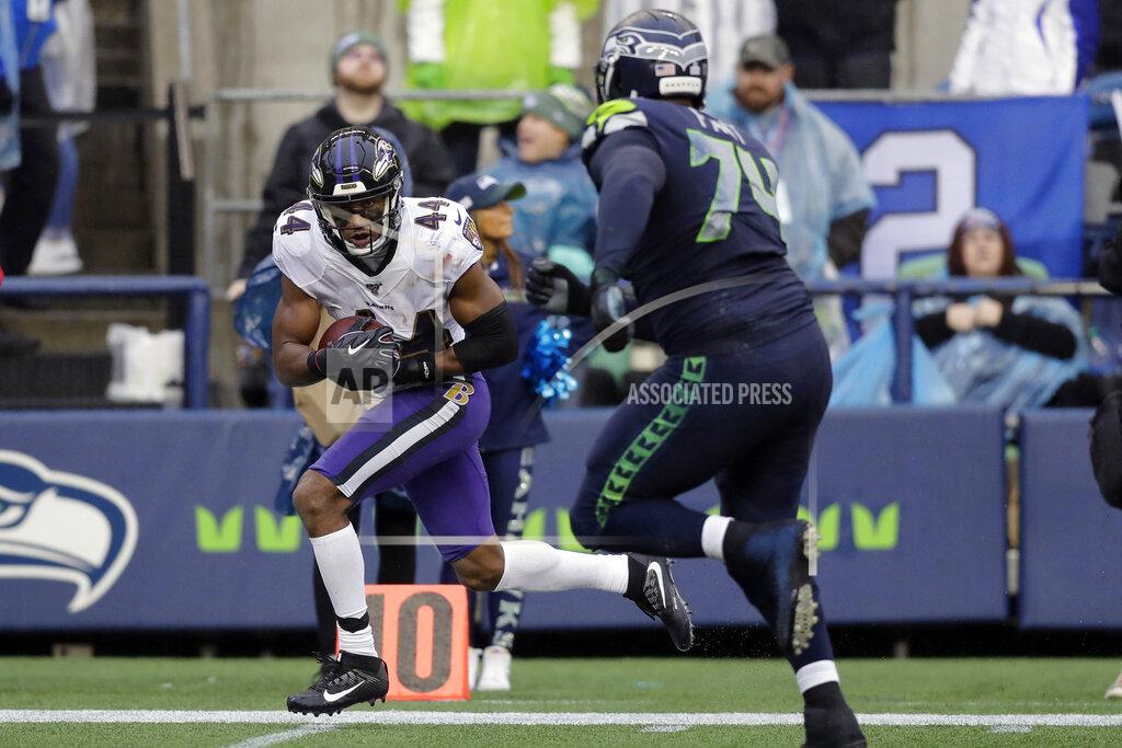 John Froschauer Baltimore Ravens cornerback Marlon Humphrey (44) runs for a touchdown after recovering a Seattle Seahawks fumble as Seahawks offensive tackle George Fant, right, pursues, during the second half of an NFL football game, Sunday, Oct. 20, 2019, in Seattle. (AP Photo/John Froschauer)