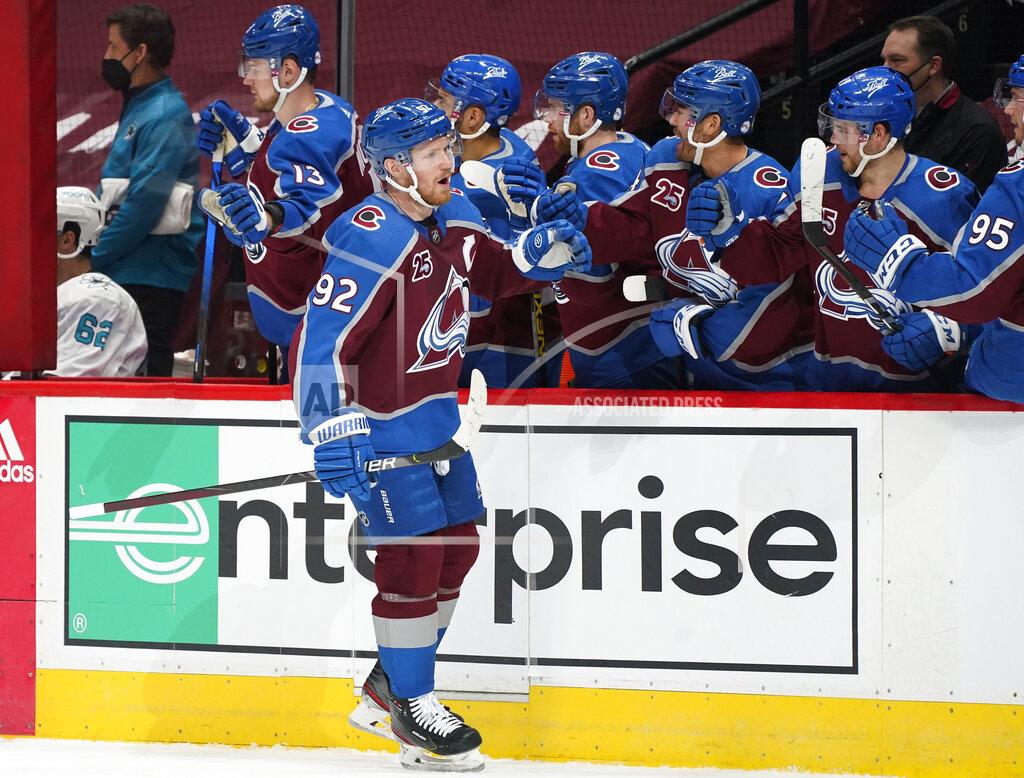 David Zalubowski Colorado Avalanche left wing Gabriel Landeskog, front, is congratulated after scoring a goal as he passes by the team box in the first period of an NHL hockey game against the San Jose Sharks, Friday, April 30, 2021, in Denver. (AP Photo/David Zalubowski)
