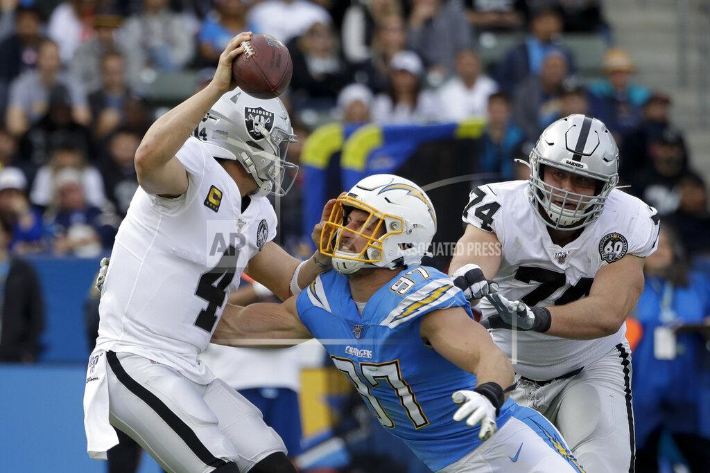 Marcio Jose Sanchez Oakland Raiders quarterback Derek Carr is sacked by Los Angeles Chargers defensive end Joey Bosa during the first half of an NFL football game Sunday, Dec. 22, 2019, in Carson, Calif. (AP Photo/Marcio Jose Sanchez)