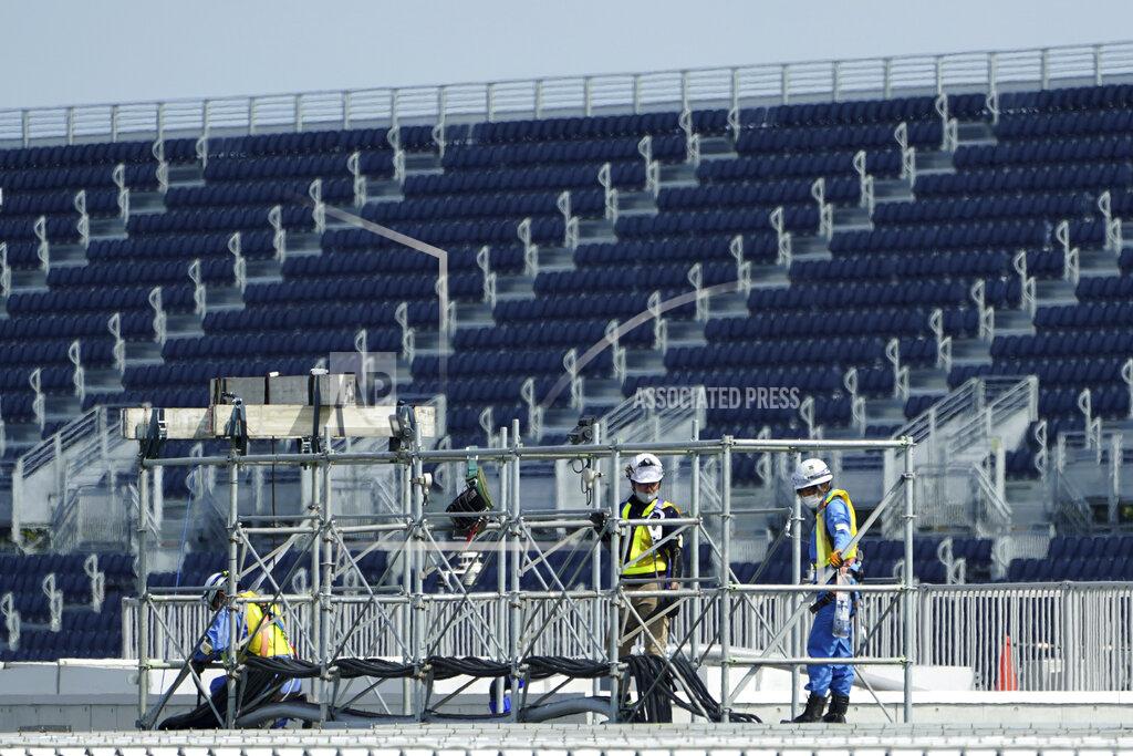 Eugene Hoshiko Workers prepare the venue at Kasai Canoe Slalom Centre for the Tokyo 2020 Olympics Thursday, April 8, 2021, in Tokyo. Many preparations are still up in the air as organizers try to figure out how to hold the postponed games in the middle of a pandemic. (AP Photo/Eugene Hoshiko)