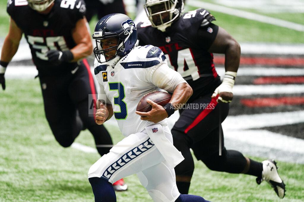 John Bazemore Seattle Seahawks quarterback Russell Wilson (3) runs for a first down against the Atlanta Falcons during the first half of an NFL football game, Sunday, Sept. 13, 2020, in Atlanta. (AP Photo/John Bazemore)