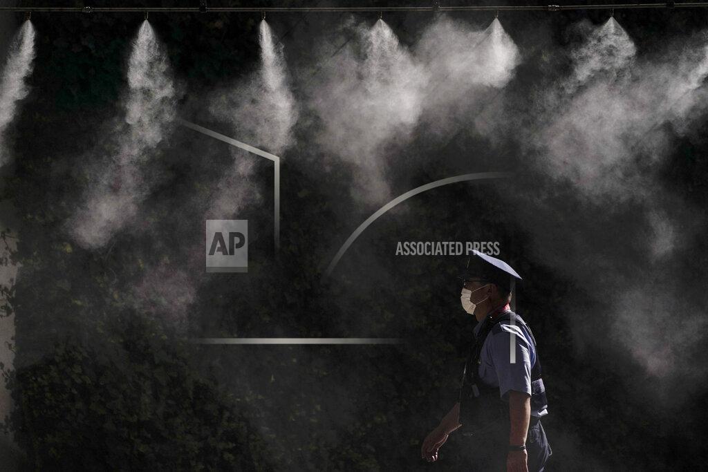 Jae C. Hong A cooling system sprays a mist over a police officer outside the main press center of the 2020 Summer Olympics, Friday, July 16, 2021, in Tokyo. (AP Photo/Jae C. Hong)
