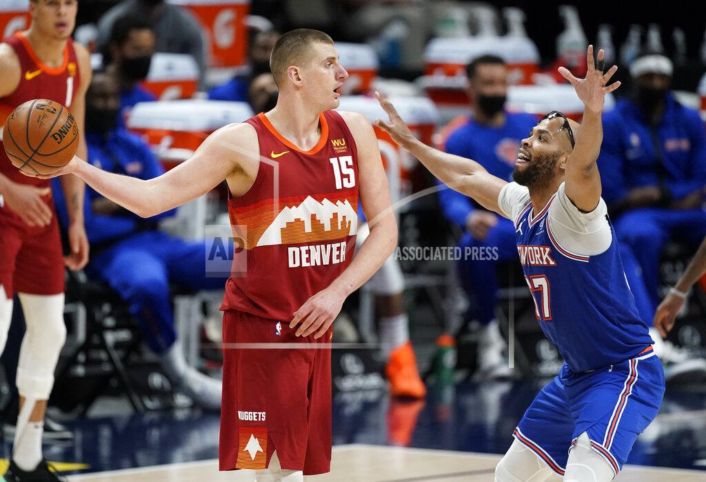 David Zalubowski Denver Nuggets center Nikola Jokic (15) looks to pass the ball as New York Knicks center Taj Gibson defends in the second half of an NBA basketball game Wednesday, May 5, 2021, in Denver. (AP Photo/David Zalubowski)