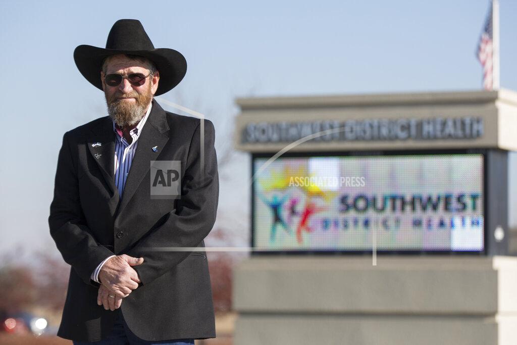 Otto Kitsinger Kelly Aberasturi, vice-chair commissioner of the board of Southwest District Health, stands outside the SWDH office in Caldwell, Idaho, on Tuesday, Nov. 24, 2020. Aberasturi doesn't support mask mandates, but he did back the board's unanimous recommendation that people in the community wear masks. He said people who believe even a recommendation goes too far have threatened to protest at his house. (AP Photo/Otto Kitsinger)
