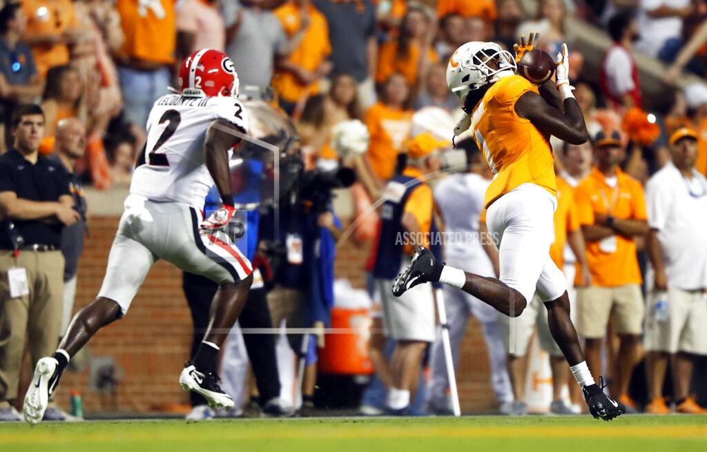Wade Payne Tennessee wide receiver Marquez Callaway (1) catches a pass en route to a touchdown as he is defended by Georgia defensive back Richard LeCounte (2) in the first half of an NCAA college football game Saturday, Oct. 5, 2019, in Knoxville, Tenn. (AP Photo/Wade Payne)