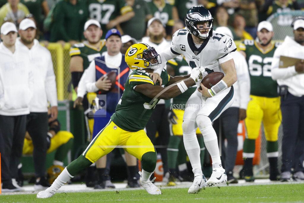 Jeffrey Phelps Philadelphia Eagles quarterback Carson Wentz is hit by Green Bay Packers strong safety Adrian Amos on a carry during the first half of an NFL football game Thursday, Sept. 26, 2019, in Green Bay, Wis. (AP Photo/Jeffrey Phelps)