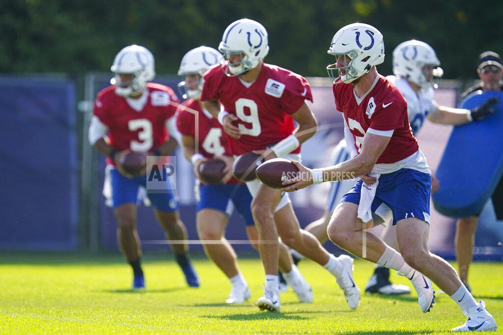 Michael Conroy Indianapolis Colts quarterback Carson Wentz (2), along with fellow quarterbacks Jacob Eason (9), Sam Ehlinger (4), and Brett Hundley (3) run a drill during practice at the NFL team's football training camp in Westfield, Ind., Monday, Aug. 23, 2021. (AP Photo/Michael Conroy)