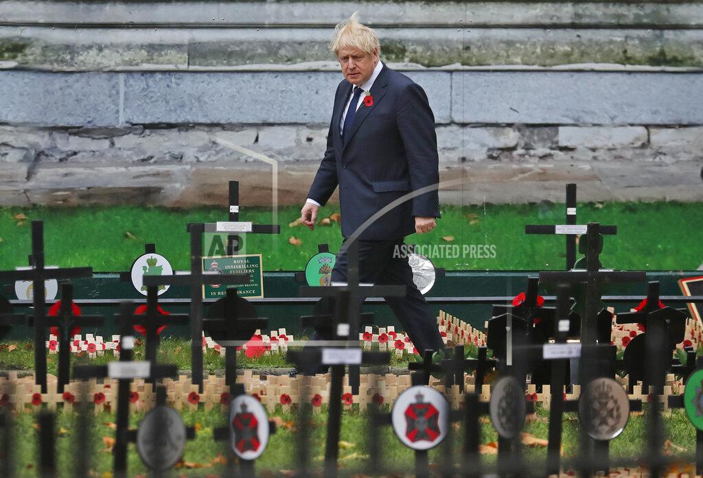 Frank Augstein Britain's prime Minister Boris Johnson walks past the 'Field of Remembrance' as he leaves Westminster Abbey after Armistice Day service in London, Wednesday, Nov. 11, 2020. Services held in many nations Wednesday will commemorate the 102nd anniversary of the armistice ending World War I and honouring all those who died in war. (AP Photo/Frank Augstein)