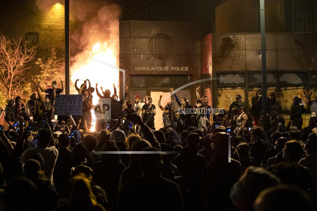 Carlos Gonzalez EDS NOTE: OBSCENITY - Protesters gesture after the Minneapolis police 3rd Precinct building was set on fire Thursday night, May 28, 2020, during demonstrations over the Monday death of George Floyd in Minneapolis police custody. (Carlos Gonzalez/Star Tribune via AP)