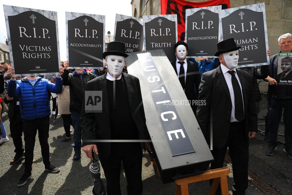 Peter Morrison Demonstrators protest outside Hillsborough Castle, ahead of a visit by British Prime Minister Boris Johnson, in Hillsborough, Northern Ireland, Monday, May, 16, 2022. Johnson on Monday renewed British threats to break a Brexit agreement with the European Union, blaming it for a political crisis that's blocking the formation of a new government in Northern Ireland. (AP Photo/Peter Morrison)