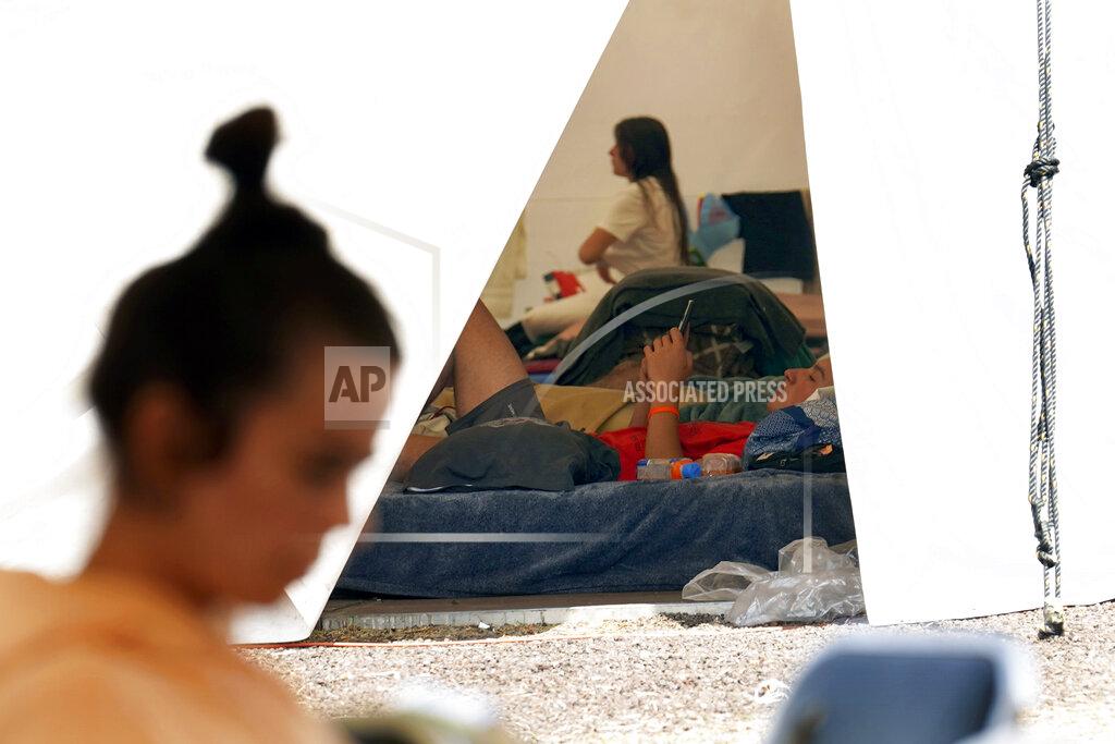 Marco Ugarte A Ukrainian teen looks at a smartphone while resting inside a tent at a refugee camp in the Iztapalapa borough of Mexico City, Tuesday, May 24, 2022. Mexico City will close the camp that has hosted hundreds of Ukrainian refugees for the past month. Now that a U.S. program vetting refugees and then allowing them to fly to the U.S. is operational, authorities say the camp is no longer needed. (AP Photo/Marco Ugarte)