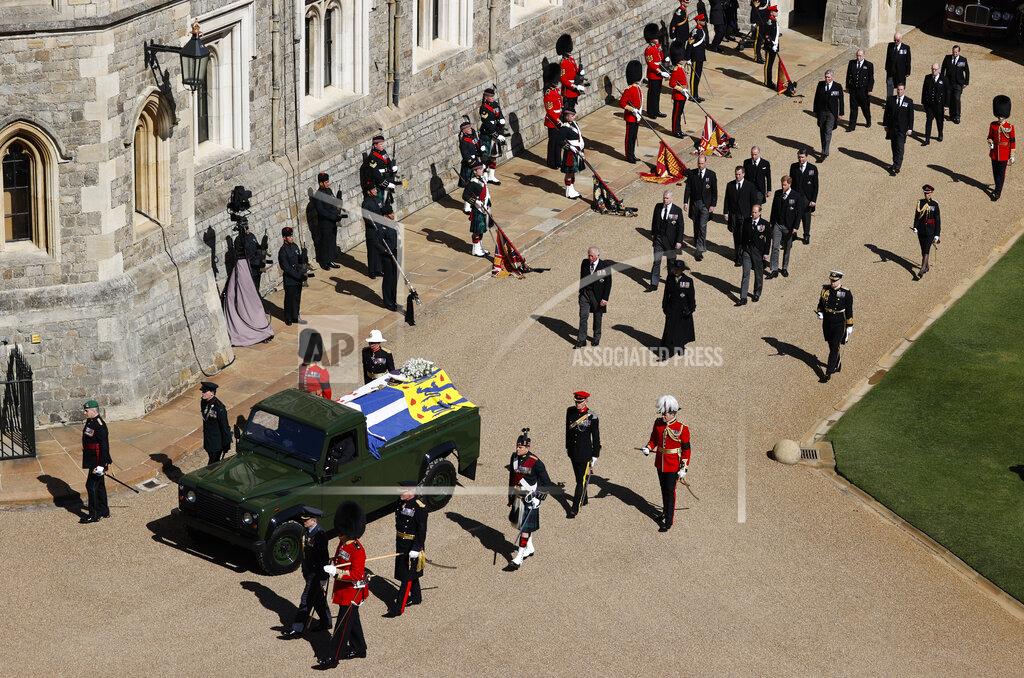Adrian Dennis Members of the Royal family, led by Prince Charles, center left, and Princess Anne, center right, follow behind the coffin of Britain's Prince Philip in the Quadrangle at Windsor Castle in Windsor, England, Saturday, April 17, 2021 ahead of the funeral of Britain's Prince Philip. Prince Philip died April 9 at the age of 99 after 73 years of marriage to Britain's Queen Elizabeth II. (Adrian Dennis/Pool via AP)
