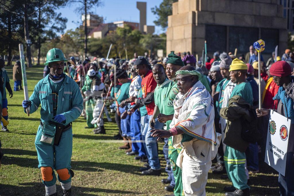 Uncredited Striking miners protest for higher wages at the Union Buildings, in Pretoria, South Africa, Tuesday, May 24, 2022 as South African President Cyril Ramaphosa receives German Chancellor Olaf Scholz. (AP Photo)