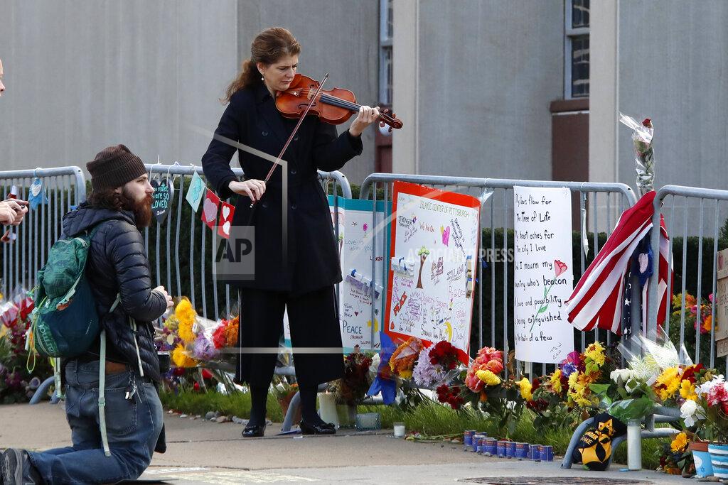 Gene J. Puskar Monique Mead plays her violin on the sidewalk outside the Tree of Life synagogue in Pittsburgh on Sunday, Oct. 27, 2019, the first anniversary of the shooting at the synagogue that killed 11 worshippers. (AP Photo/Gene J. Puskar)