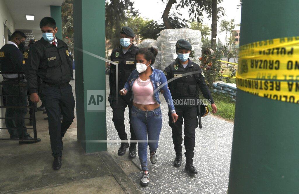 Martin Mejia Police officers escort a woman who was detained at a disco where thirteen people died during a stampede in Lima, Peru, Sunday, Aug. 23, 2020. Officials said the stampede happened at a disco after a police raid to enforce the country's lockdown during the coronavirus pandemic. (AP Photo/Martin Mejia)