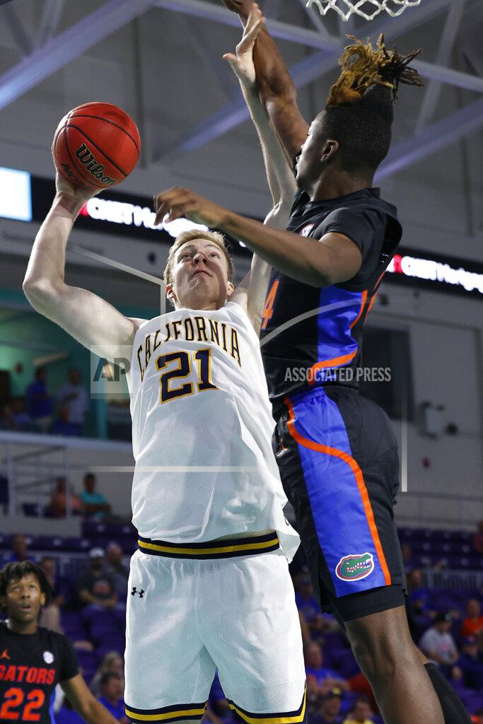 Scott Audette California forward Lars Thiemann (21) shoots past Florida guard Kowacie Reeves (14) during the second half of an NCAA college basketball game on Monday, Nov. 22, 2021, in Fort Myers, Fla. (AP Photo/Scott Audette)