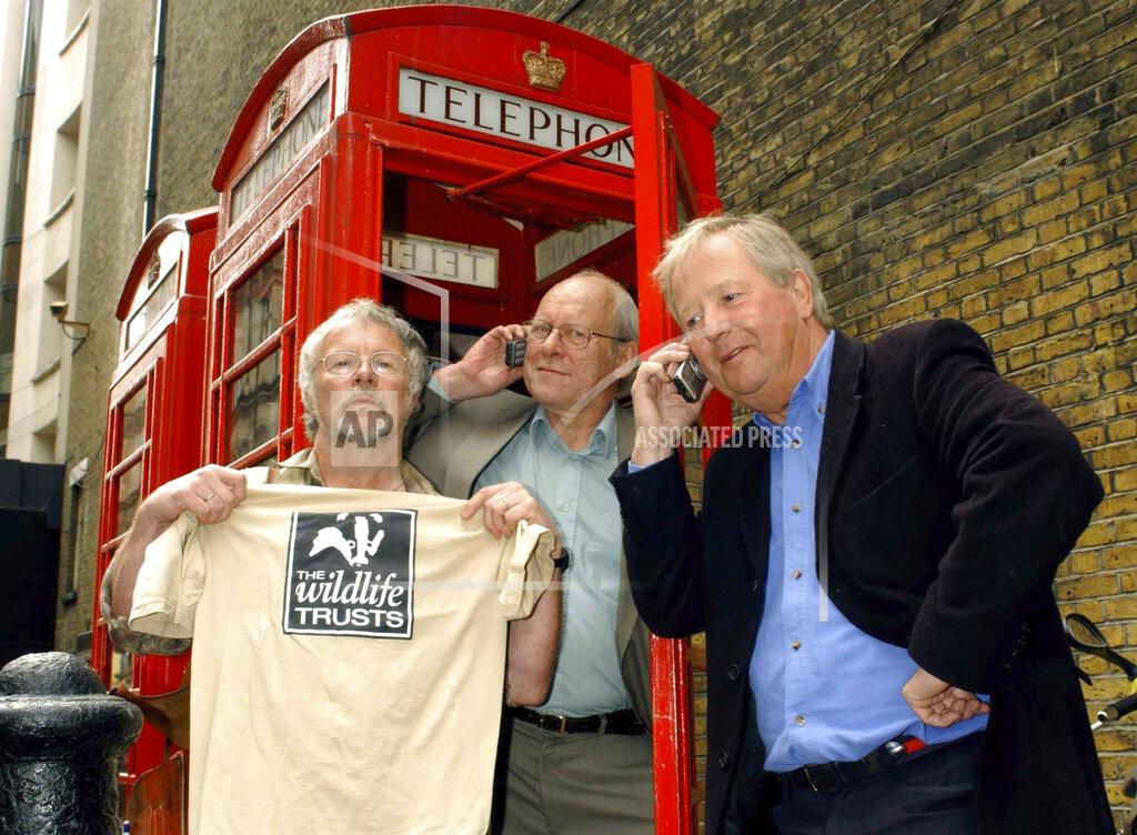 Yui Mok FILE - In this April 24, 2003 file photo, The Goodies, from left, Bill Oddie, Graeme Garden and Tim Brooke-Taylor pose for the media outside The Prince Charles Cinema in Leicester Place, central London. British comedian Tim Brooke-Taylor, a member of comedy trio The Goodies, has died after contracting the new coronavirus. He was 79. Brooke-Taylor’s agent says he died Sunday, April 12, 2020 “from COVID-19.” (Yui Mok/PA via AP, file)