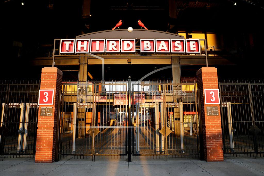 Jeff Roberson An entrance to Busch Stadium, home of the St. Louis Cardinals, remain closed Friday, Aug. 7, 2020, in St. Louis. Major League Baseball announced Friday night that the entire three-game series between the Chicago Cubs and Cardinals set for this weekend in St. Louis has been postponed after two more Cardinals players and a staff member tested positive for the coronavirus. (AP Photo/Jeff Roberson)
