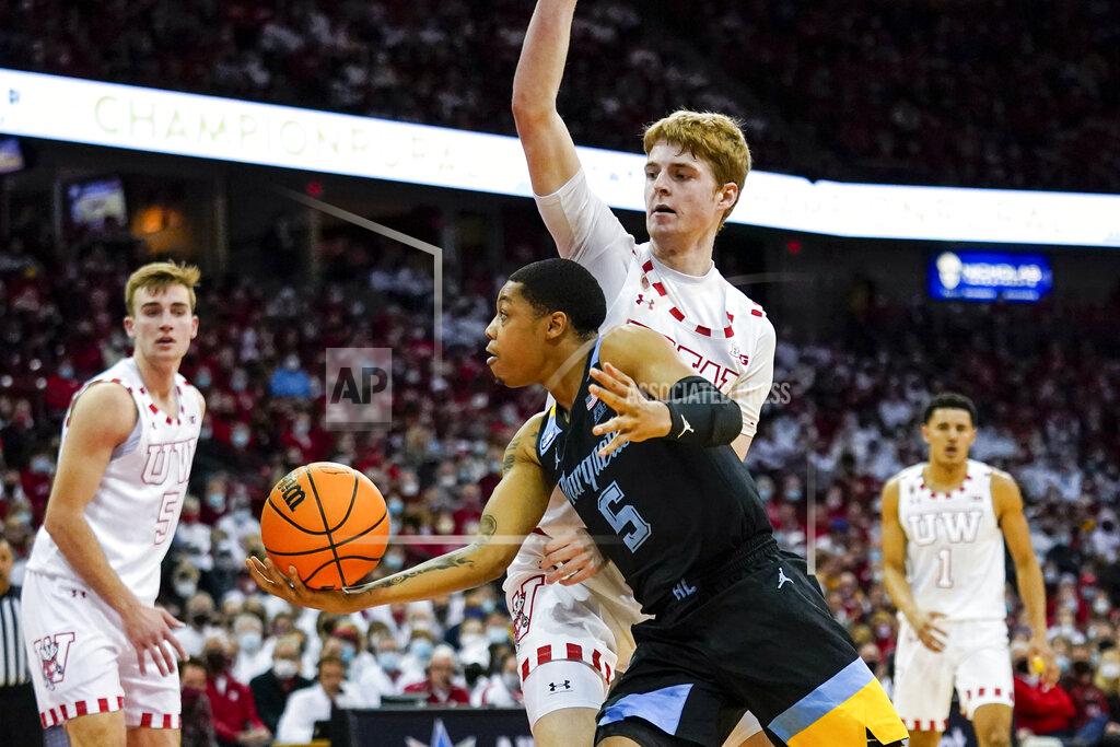 Andy Manis Marquette's Greg Elliott (5) shoots against Wisconsin's Steven Crowl (22) during the first half of an NCAA college basketball game Saturday, Dec. 4, 2021, in Madison, Wis. (AP Photo/Andy Manis)