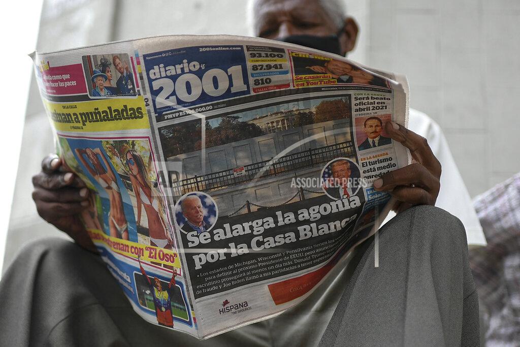 Matias Delacroix A man reads the Diario 2001 newspaper that carries the Spanish headline: "Agony is prolonged for the White House" at a newspaper stand in Caracas, Venezuela, Wednesday, Nov. 4, 2020, the day after U.S. elections. (AP Photo/Matias Delacroix)