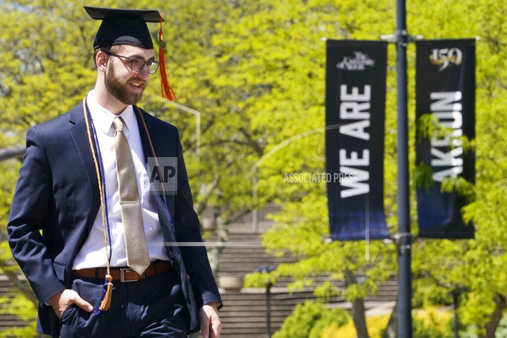 Tony Dejak Recent University of Akron graduate Matthew Yokosuk poses for photo on campus, Thursday, May 13, 2021, in Akron, Ohio. Ohio Gov. Mike DeWine recently announced a weekly $1 million prize and full-ride college scholarships to entice more Ohioans to get the COVID-19 vaccine. (AP Photo/Tony Dejak)