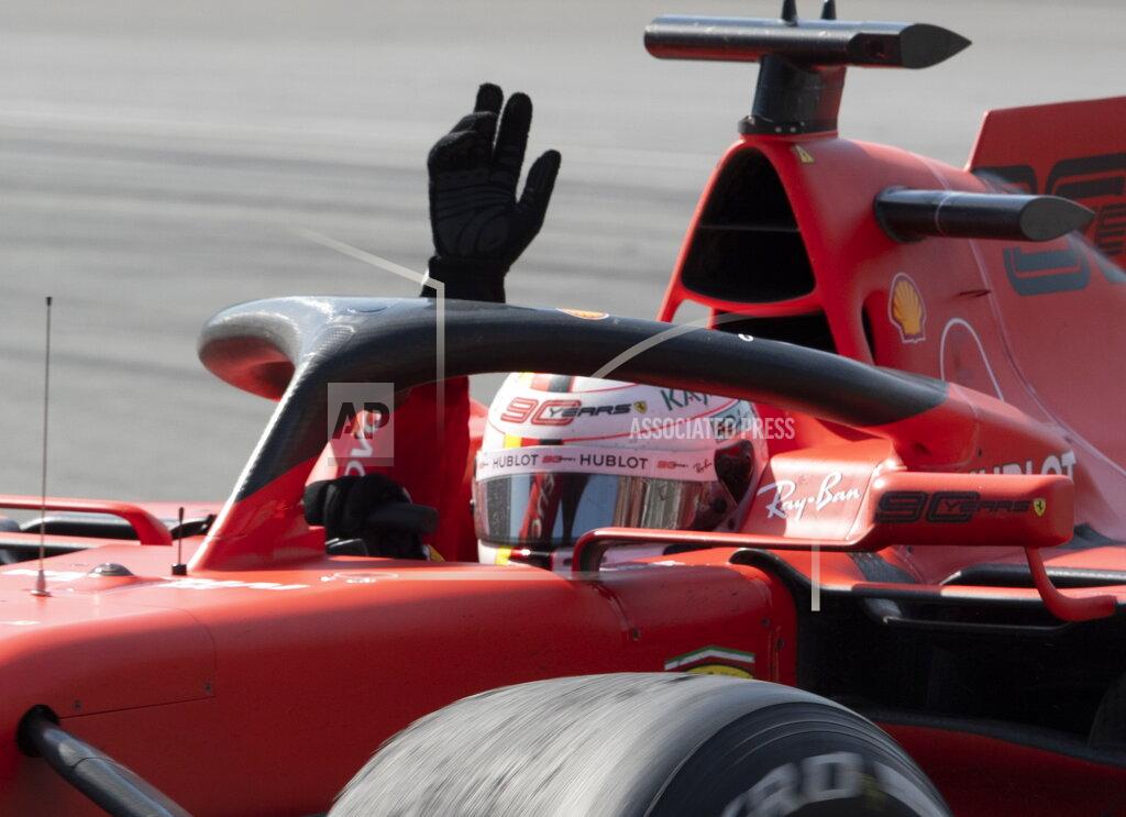 Jacques Boissinot Ferrari driver Sebastian Vettel, of Germany, waves to the crowd after finishing in second place because of a penalty at the Formula One Canadian Grand Prix auto race in Montreal, Sunday, June 9, 2019. (Jacques Boissinot/The Canadian Press via AP)
